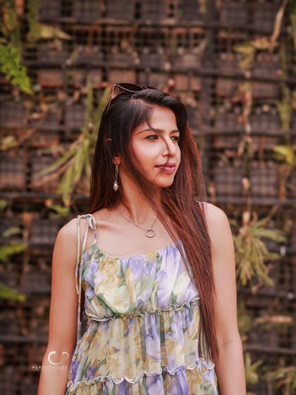 A thoughtful profile shot against a wall of greenery. The natural textures and soft light create a calm and organic feel.