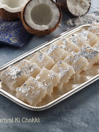 A platter of our signature Nariyal ki Chakki, made with fresh coconut and garnished with edible silver leaf. It's a taste of pure, homemade tradition.