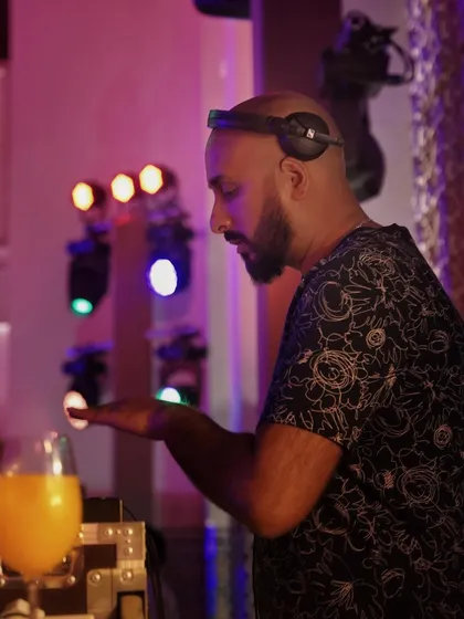 In the zone, mixing tracks at a wedding reception in Marrakech. The colorful lighting adds to the vibrant atmosphere.