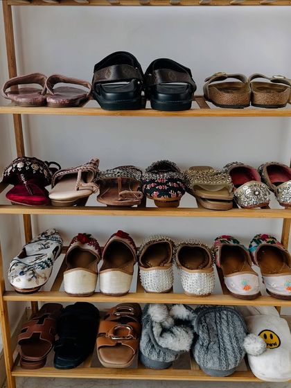 A simple yet effective bamboo shoe rack keeps daily-wear shoes organized. We arranged these by type, with Indian juttis, sandals, and slippers all having their own shelf.