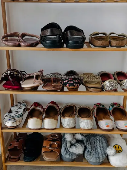 A neatly organized shoe rack for celebrity clients Jasmin and Aly. We categorized their footwear, including daily wear, Indian juttis, and slippers, for easy access.