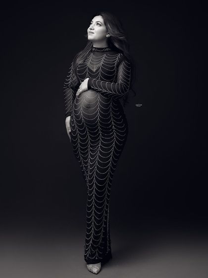 A full-length black and white shot of the embellished gown, giving it a classic, old-Hollywood feel.