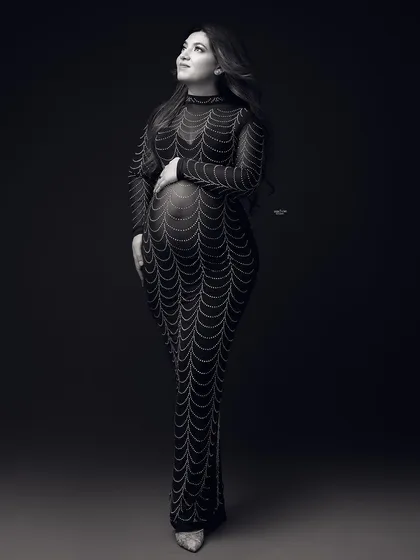 A full-length black and white shot of the embellished gown, giving it a classic, old-Hollywood feel.