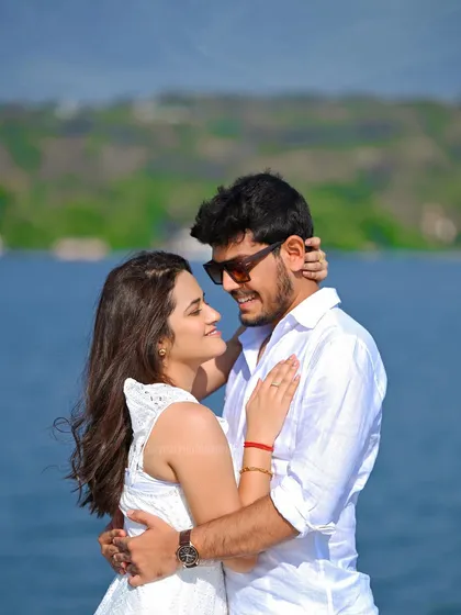 A close-up, intimate moment between the couple on a boat, with the blue water creating a simple and beautiful background for their pre-wedding portrait.