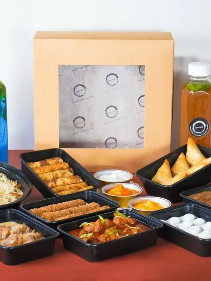 The complete Iftar feast, unboxed and ready to be served. This image showcases the sheer variety and quantity of food you receive, from multiple main courses and biryani to a selection of starters, desserts, and colorful beverages.