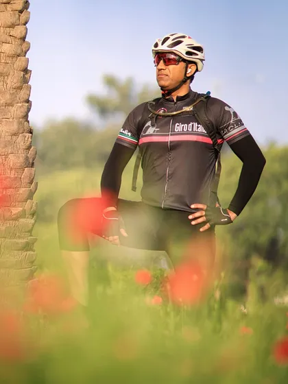 A cyclist posing in a field of flowers. We always find beauty in our surroundings.