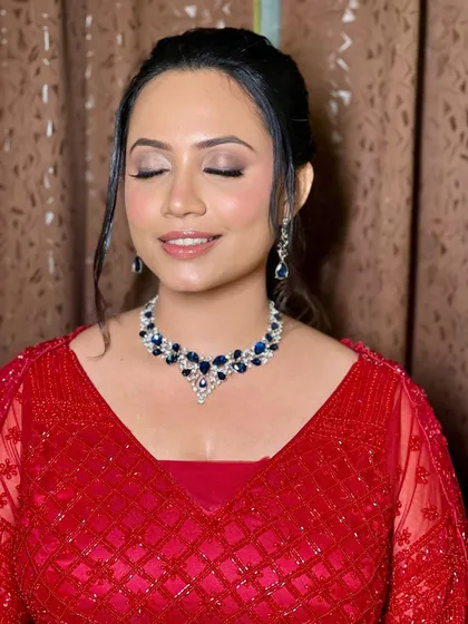 Eyes closed to showcase the beautiful, soft smoky eye makeup for her sangeet.