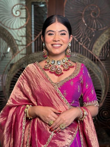 A happy and radiant smile! The makeup is designed to enhance her natural beauty and give her a beautiful, healthy glow.