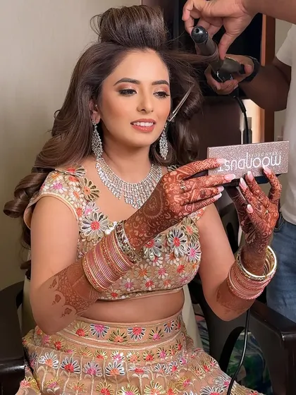 A fun behind the scenes moment. Even with rollers in her hair, you can see the beautiful eye makeup and glowing skin coming together.