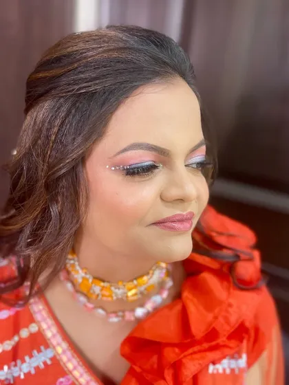 A creative eye makeup look with small rhinestones along the crease, adding a touch of sparkle for a pre-wedding party.