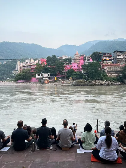 Our sangha meditates together on the banks of the holy Ganges during a yoga retreat in Rishikesh. Practicing in nature amplifies the sense of peace and connection to the universal spirit.