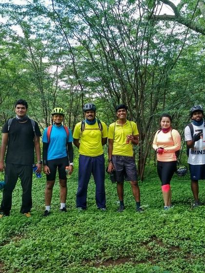 The group lined up for a photo in a beautiful, wooded area. These are the moments we ride for.