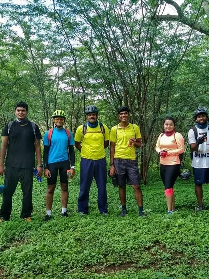 The group lined up for a photo in a beautiful, wooded area. These are the moments we ride for.