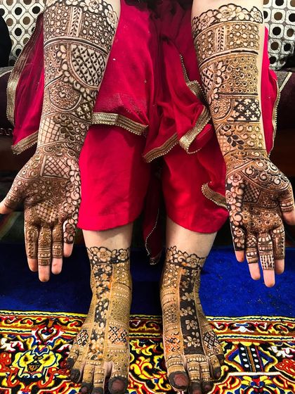 The complete bridal package. This photo shows a coordinated set of full-coverage mehendi for both hands and feet, ensuring a consistent and traditional look for the bride.
