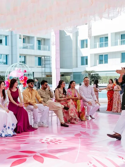 Setting up a game for the wedding party. Involving the bridesmaids and groomsmen is a great way to add a personal touch to the celebration.