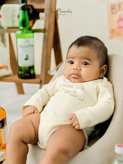 The little boss of the bar. This baby's serious expression is the perfect contrast to the playful, miniature bar theme.