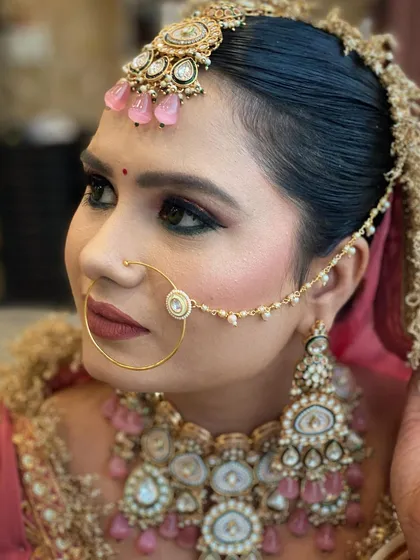 This close up highlights the sharp, defined eye makeup and the traditional nath (nose ring). It shows my attention to detail in creating a complete and authentic Punjabi bridal look.
