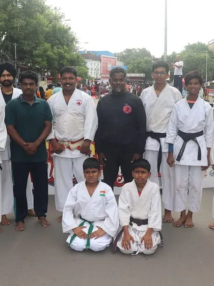 Posing with students from another karate school at the "Happy Streets" event. We believe in unity and respect across all martial arts disciplines.