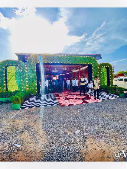 The grand entrance we constructed for 'The Bhosale Wedding'. We created a custom structure with a lush green facade and a dramatic black-and-white patterned floor to welcome guests.
