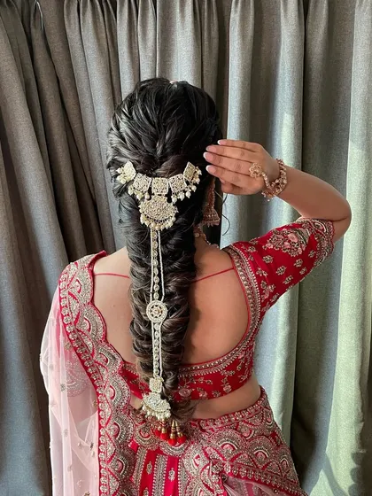 A beautiful textured bridal braid. I love how the intricate fishtail braid is adorned with a stunning traditional accessory, creating a look that is both modern and timeless.