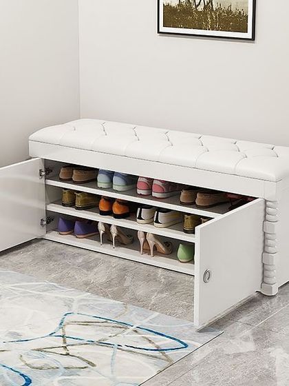 Another one of our shoe rack bench designs, this time in a classic white finish with a tufted leatherette seat. The cabinet doors open to reveal ample shelving for shoes, keeping your entryway tidy and organized.