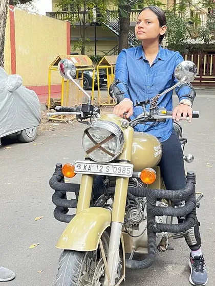 A graduate sits confidently on her bike, ready for her next ride. She has the skills and the attitude to conquer any road.