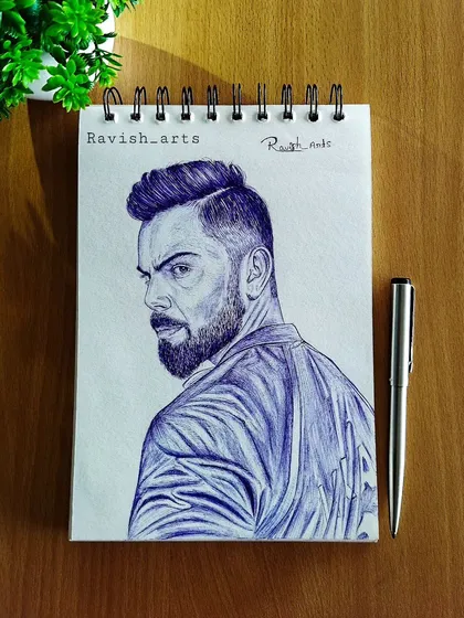 A finished ballpoint pen portrait of Virat Kohli, created to celebrate his 76th century. The blue ink gives it a distinct and striking look.