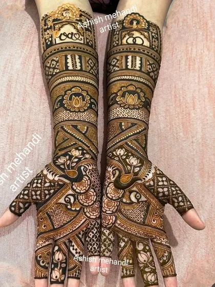 This design is all about symmetry and detail. Notice the matching peacock figures and lotus bands on both hands, a testament to our precision and skill in creating complex bridal mehandi.