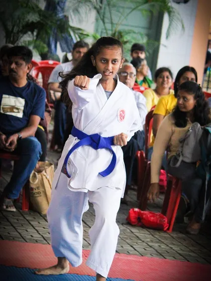A student demonstrates a powerful and focused punch during a championship event. Our training prepares children to perform with confidence, showcasing the strength and precision they have developed through dedicated practice.