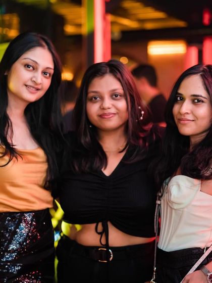 Friends enjoying the vibe at The Fixx Bar. The warm lighting and great music create a perfect atmosphere.