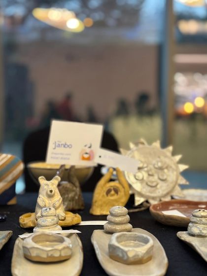A close-up of our flea market display, showing some of our whimsical sculptures and incense holders.