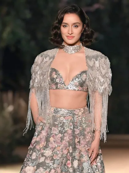 Actress Shraddha Kapoor looking radiant on the runway. This close-up portrait captures her beauty and the intricate details of her sequined floral lehenga.