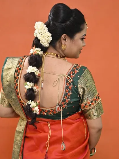 A view of the beautiful traditional braided hairstyle, adorned with fresh jasmine flowers, which I coordinated with the hairstylist for this baby shower look.
