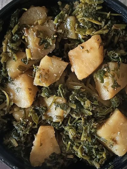 A bowl of simple and healthy Aloo Methi sabzi. The combination of potatoes and fresh fenugreek leaves is a winter favorite in my kitchen.