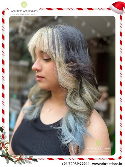 A high-fashion look combining a dark base with a split dye of platinum blonde and pastel blue for a truly artistic and unique style.