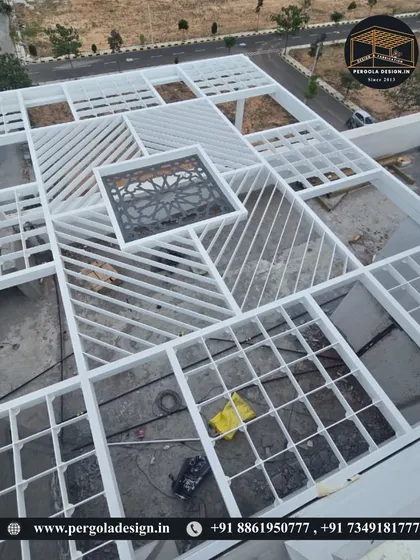 An aerial shot of a massive, intricate white pergola structure under construction, showcasing our ability to handle large and complex geometric designs.
