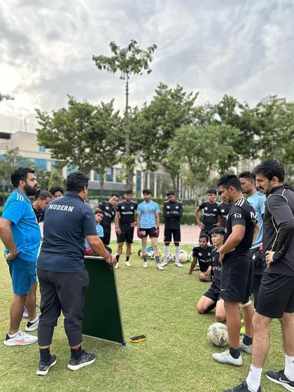 "It's the will to prepare to win that matters." Our coaches using a whiteboard to explain tactics to the senior team, reinforcing our identity as mentality monsters.