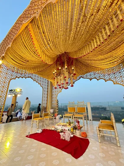 Set against the open sky, this rooftop mandap combines traditional elegance with a breathtaking view. I used intricate jaali work arches and a dense canopy of auspicious marigold garlands to create a sacred and royally vibrant wedding ceremony space.