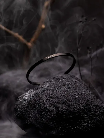 Accessory photography is about creating a mood. Here, I used dramatic, low-key lighting with smoke and natural elements to give this minimalist bracelet a bold, masculine, and luxurious feel for a creative product campaign.