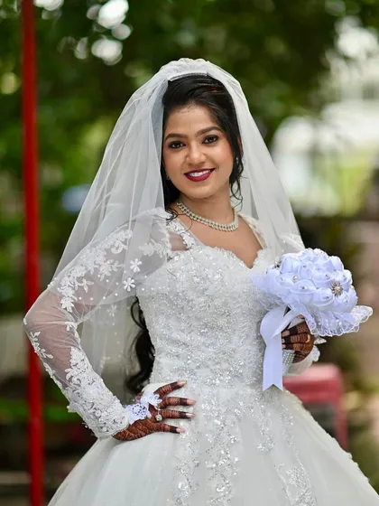 For my Christian brides, I aim for an aura of soft, ethereal glam. This look features a flawless HD makeup base that lasts through vows and celebrations, a defined eye, and a bold lip that complements the pristine white gown, ensuring she feels timeless and graceful.