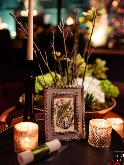 A small detail from the glass house reception. A hand-drawn sketch in a frame sits beside candles, showing our love for adding personal, art-inspired touches to every event.