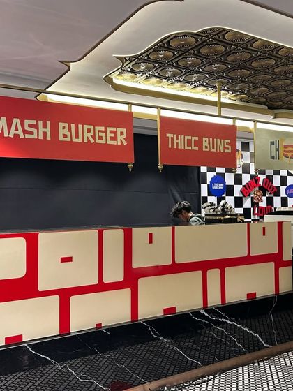 The custom-built food counter for the Krok Burgers launch. We designed the counter with branded signage like "SMASH BURGER" and "THICC BUNS" to align with the brand's playful and modern identity.