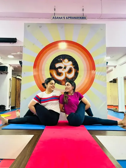 A partner spinal twist, based on Ardha Matsyendrasana. This pose helps to release tension in the back and improve digestive health while enjoying the connection of a shared practice.