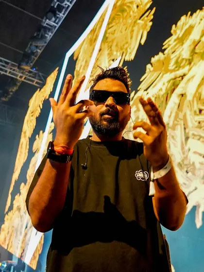 Throwing up signs for the camera against a massive, colorful LED screen. The visuals are a huge part of my live show.