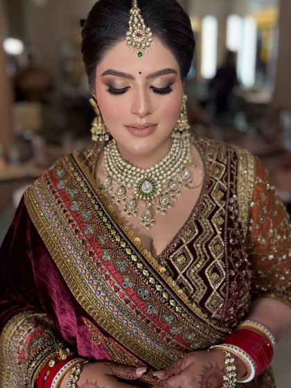 The complete bridal look, showing the rich texture of the velvet outfit and the perfectly coordinated makeup. This is a perfect example of a winter wedding bridal style.
