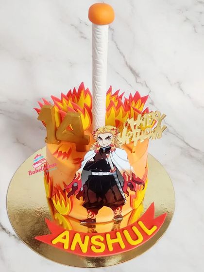A fiery Demon Slayer cake for a 14th birthday. The orange ombre cake is decorated with edible flames and a character cutout to bring the anime to life.