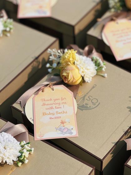 A close-up of the custom tag for a baby shower, reading "Thank you for showering me with love". We work with you to create personalized stationery for your event.