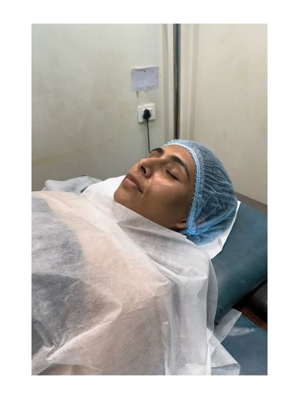 A moment of pure relaxation. A client rests peacefully during a facial therapy session, allowing the herbal ingredients to work their magic.