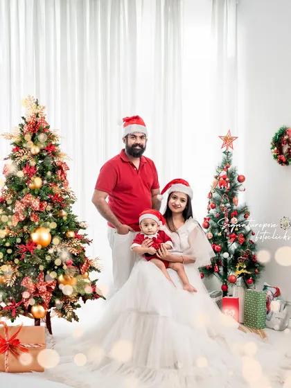 Creating your family's annual holiday card is a special tradition. This Christmas-themed family portrait was taken in my studio with a festive setup, including decorated trees and soft lighting. I aim to create a warm and joyful atmosphere for a classic family photo you'll cherish for years.
