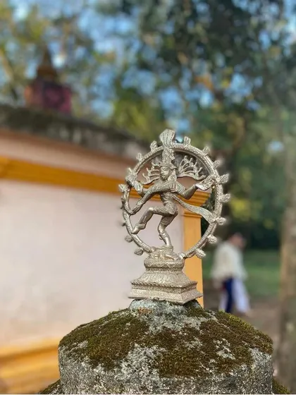A statue of Nataraja, the dancing Shiva, stands at the ashram entrance. This symbol represents the cosmic dance of creation and destruction, a key concept in yogic philosophy.